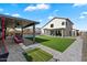 Beautiful backyard showcasing artificial turf, a pool, an outdoor kitchen, and a covered patio at 19002 N 25Th Pl, Phoenix, AZ 85050