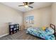 Comfortable bedroom with a ceiling fan, window, and a whimsical decor theme at 19002 N 25Th Pl, Phoenix, AZ 85050
