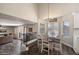 Bright dining room with high ceilings, wood floors, and a modern chandelier at 19002 N 25Th Pl, Phoenix, AZ 85050