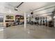 Spacious garage with epoxy flooring, storage shelves, and fitness equipment at 19002 N 25Th Pl, Phoenix, AZ 85050