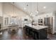 Modern kitchen with stainless steel appliances, a large island, and stylish pendant lighting at 19002 N 25Th Pl, Phoenix, AZ 85050