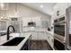 Contemporary kitchen featuring white cabinets, modern appliances, and an island with seating at 19002 N 25Th Pl, Phoenix, AZ 85050