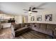 Spacious living room with wood floors, ceiling fan, and neutral color scheme at 19002 N 25Th Pl, Phoenix, AZ 85050