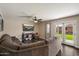Comfortable living room with a large sectional sofa and access to the backyard at 19002 N 25Th Pl, Phoenix, AZ 85050