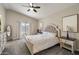 Inviting main bedroom with carpet flooring, ceiling fan, and neutral tones at 19002 N 25Th Pl, Phoenix, AZ 85050