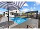 Beautiful backyard with a pool, patio umbrella, covered patio, and outdoor dining area at 19002 N 25Th Pl, Phoenix, AZ 85050