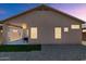 Exterior view of the house with a covered patio, gravel yard, and small patch of grass at 19860 N 110Th Ln, Peoria, AZ 85373