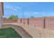 This backyard has a low-maintenance desert landscaping and a block fence at 19860 N 110Th Ln, Peoria, AZ 85373