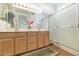 Bright bathroom features a double sink vanity and separate glass enclosed shower at 19860 N 110Th Ln, Peoria, AZ 85373