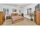 Carpeted bedroom features white walls, shuttered windows, ceiling fan, and wooden furniture at 19860 N 110Th Ln, Peoria, AZ 85373