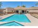 Resort-style community pool featuring a hot tub, tanning chairs, and beautiful common areas at 19860 N 110Th Ln, Peoria, AZ 85373