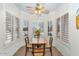 Bright breakfast nook features a wood table and chairs by shuttered windows at 19860 N 110Th Ln, Peoria, AZ 85373