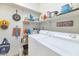 Organized laundry area has shelves and modern washer and dryer units at 19860 N 110Th Ln, Peoria, AZ 85373