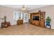Living area with tile flooring, a ceiling fan, built-in shelving, and a sliding glass door at 19860 N 110Th Ln, Peoria, AZ 85373