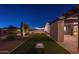 Backyard featuring a well-manicured lawn area with artificial turf and a charming cornhole setup at 20151 E Via Del Palo St, Queen Creek, AZ 85142