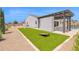 Spacious backyard featuring a cornhole set, a bocce ball court and a pergola covered outdoor space at 20151 E Via Del Palo St, Queen Creek, AZ 85142