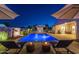 Stunning backyard pool with water features, lounge chairs, and umbrellas for relaxing evenings at 20151 E Via Del Palo St, Queen Creek, AZ 85142