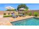 Tranquil backyard pool area features lounge chairs and landscaping for relaxation at 20151 E Via Del Palo St, Queen Creek, AZ 85142