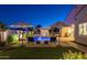Resort-style backyard with a pool, water features, lush landscaping, and seating areas for relaxation at 20151 E Via Del Palo St, Queen Creek, AZ 85142
