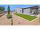 Spacious backyard with artificial turf, pergola, and landscaping for outdoor living and entertaining at 20151 E Via Del Palo St, Queen Creek, AZ 85142