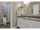 Bright bathroom with a double sink vanity, marble countertop, and decorative mirrors at 20151 E Via Del Palo St, Queen Creek, AZ 85142
