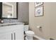 Stylish half-bathroom with decorative mirror and a gray accent wall at 20151 E Via Del Palo St, Queen Creek, AZ 85142