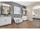 Modern bathroom with freestanding tub, double vanities, sleek lighting, and natural light at 20151 E Via Del Palo St, Queen Creek, AZ 85142