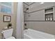 Clean bathroom featuring bathtub with shower and stylish gray and white tile accents at 20151 E Via Del Palo St, Queen Creek, AZ 85142