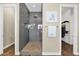 Contemporary bathroom featuring a glass-enclosed shower and a glimpse into the walk-in closet at 20151 E Via Del Palo St, Queen Creek, AZ 85142