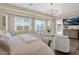 Bright main bedroom with plush seating area, multiple windows, and backyard mountain views at 20151 E Via Del Palo St, Queen Creek, AZ 85142