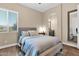 Cozy bedroom with a plush bed, archway to bathroom, and a neutral color scheme at 20151 E Via Del Palo St, Queen Creek, AZ 85142