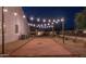 Well-maintained bocce ball court in backyard is framed by gravel and wooden borders under string lights at 20151 E Via Del Palo St, Queen Creek, AZ 85142