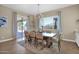 Open dining room with elegant chandelier and sliding doors to the outdoor patio at 20151 E Via Del Palo St, Queen Creek, AZ 85142