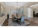 Dining room features a chandelier, artwork, and a table set for six, with wood-look floors at 20151 E Via Del Palo St, Queen Creek, AZ 85142