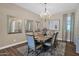 Elegant dining room featuring a chandelier, wood floors, and a large table set for a meal at 20151 E Via Del Palo St, Queen Creek, AZ 85142