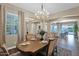 Open-concept dining area with backyard views, chandelier, and beautifully arranged table setting at 20151 E Via Del Palo St, Queen Creek, AZ 85142
