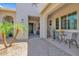 Inviting front entrance with a paved walkway, a seating area, a palm tree and an ornate front door at 20151 E Via Del Palo St, Queen Creek, AZ 85142