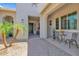 Inviting front entrance with a brick walkway, decorated table, and outdoor seating and plants at 20151 E Via Del Palo St, Queen Creek, AZ 85142