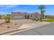 Attractive home exterior with a circular driveway, desert landscaping, and a spacious two-car garage at 20151 E Via Del Palo St, Queen Creek, AZ 85142