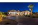 Inviting single-story home with brick-paved driveway, well-maintained landscaping, and a three-car garage at 20151 E Via Del Palo St, Queen Creek, AZ 85142