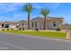Attractive front exterior with well-manicured landscaping, palm trees, and lush green grass at 20151 E Via Del Palo St, Queen Creek, AZ 85142