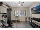 Home gym with treadmill, weights, and television for entertainment during workouts at 20151 E Via Del Palo St, Queen Creek, AZ 85142