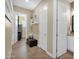 Hallway featuring a cushioned bench, white doors, and transitional access to various rooms at 20151 E Via Del Palo St, Queen Creek, AZ 85142