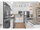 Gourmet kitchen featuring stainless steel appliances and custom white cabinetry at 20151 E Via Del Palo St, Queen Creek, AZ 85142