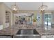 Contemporary kitchen with a deep sink, granite countertops, pendant lighting, and an open view to the living area at 20151 E Via Del Palo St, Queen Creek, AZ 85142
