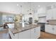 Bright kitchen with a large center island, stainless steel appliances, and an adjacent dining area at 20151 E Via Del Palo St, Queen Creek, AZ 85142