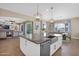 Open-concept kitchen featuring a large island, a modern sink, and seamless flow into the living room at 20151 E Via Del Palo St, Queen Creek, AZ 85142