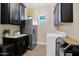 Convenient laundry room with washer, dryer, and storage cabinets for supplies at 20151 E Via Del Palo St, Queen Creek, AZ 85142