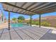 Inviting backyard featuring an outdoor living space under a pergola, with a view of the pool at 20151 E Via Del Palo St, Queen Creek, AZ 85142