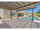 Spacious outdoor pergola overlooking a sparkling swimming pool with an outdoor entertainment area at 20151 E Via Del Palo St, Queen Creek, AZ 85142